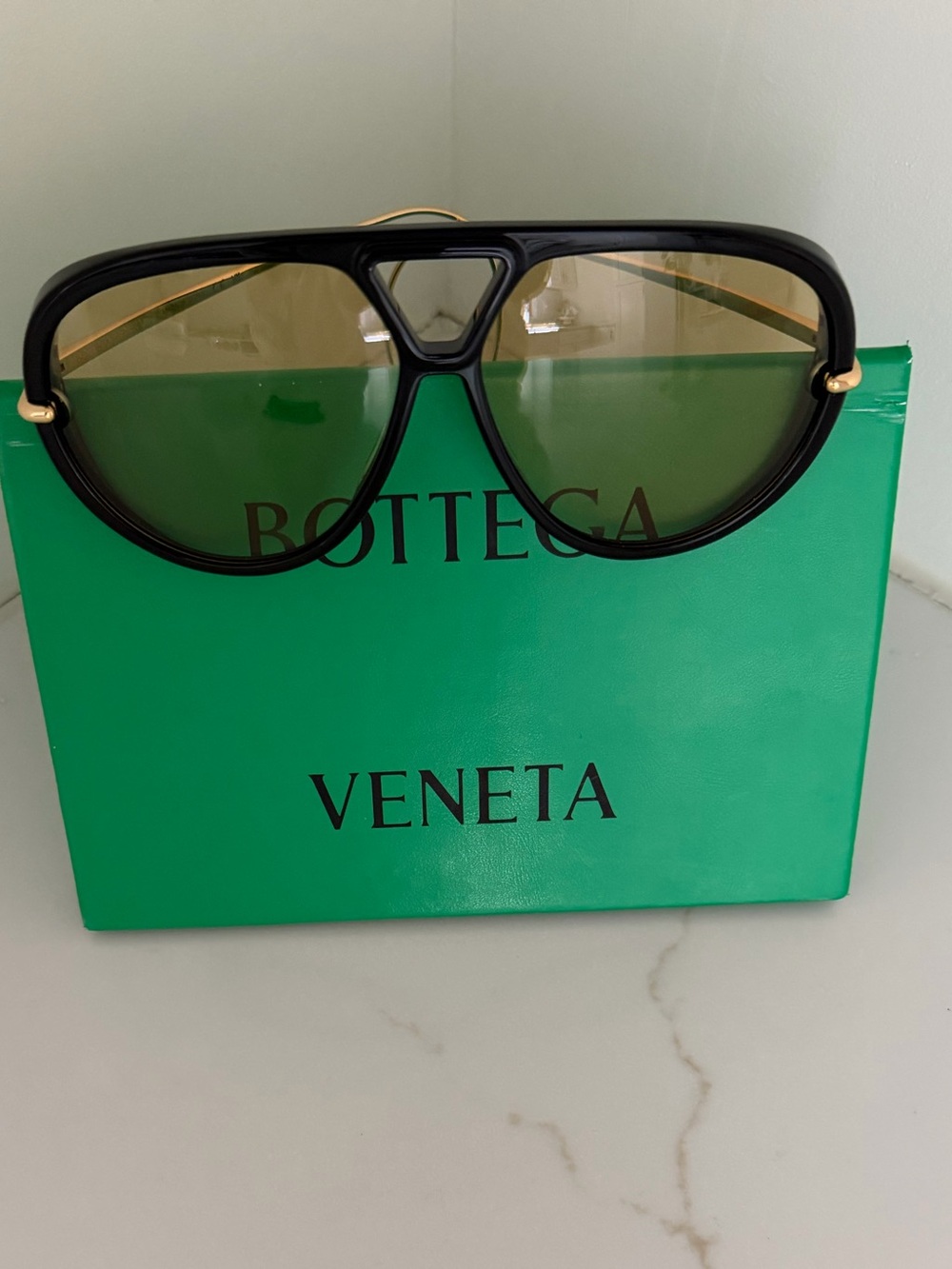 Bottega Veneta Black Frame Sunglasses with Green Lenses